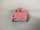 a pink toy car that is sitting on a table