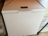 an image of a small white refrigerator in a room