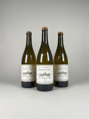 three bottles of wine sitting next to each other on a table
