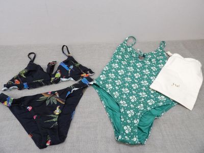 two bikinis and a t - shirt on a bed