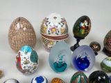 many different types of glass eggs on a table