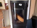 a black stove sitting in a room with a sign on the wall