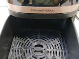 a person taking a picture of themselves in the reflection of a toaster