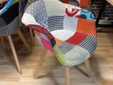many different colored chairs in a room with a brick wall