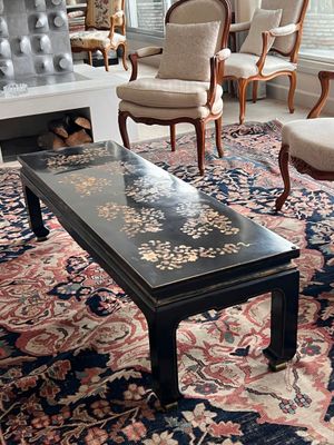 une photo d'un salon avec des fauteuils et une table basse