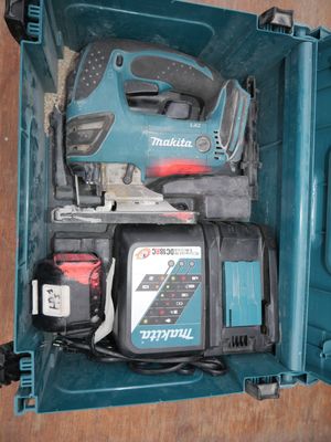 a blue tool box with tools in it on a table