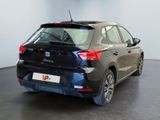 the rear end of a black car in a showroom