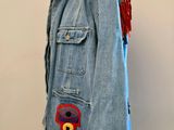 denim jacket with red and blue appliqued on the back