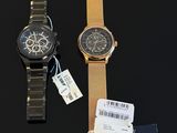 two watches on a black surface with a price tag and a price tag