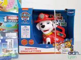 a toy dog that is in a box next to other toys