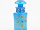 blue glass vase with a gold design on the top of it