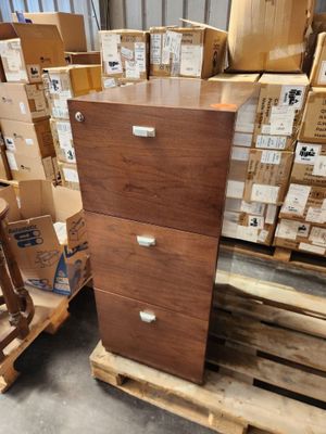 a tall wooden filing cabinet in the middle of a pile of boxes