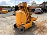 a small yellow machine that is sitting in the dirt
