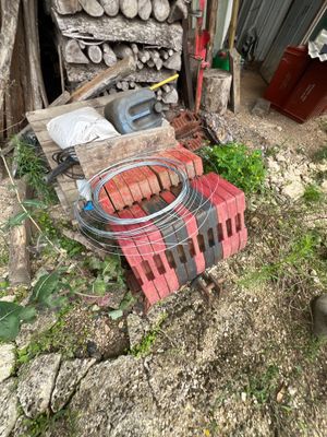 a fire pit with a bunch of hot dogs cooking on it