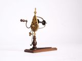 a clock that is on a wooden stand on a white background