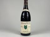 an old bottle of wine sitting on top of a white table