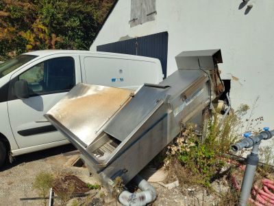 a white van parked next to a building with a grill on it