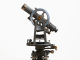a very old telescope on a stand on a white background