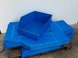 a pile of blue plastic bins sitting on top of a wooden pallet