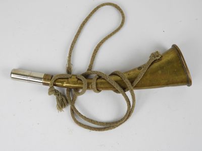 an old brass telescope with a rope around it on a white surface