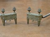 two statues that are sitting on a bench