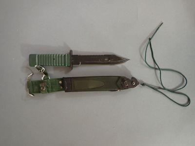 two different types of knives on a white surface