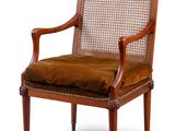 the chair is made of wood and has a brown upholstered seat