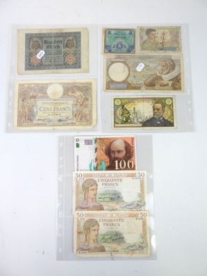 many different types of currency on display on the wall