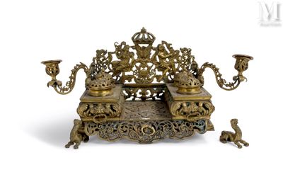 a gold colored candle holder on a white background
