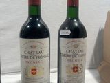 three bottles of wine sitting on top of a table next to a brown bag