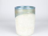 a blue and white cup that is sitting on a table
