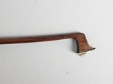 a close up of a wooden handle on a white surface