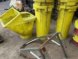 many yellow buckets sitting on the ground next to a red fire hydrant