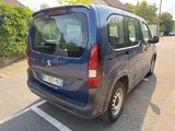 a small blue van parked in a parking lot