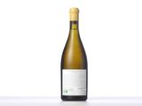 the bottle of white wine is sitting on the table