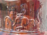 a glass vase with a picture of a horse and rider on it