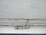 cracks in the ceiling of an old building with peeling paint on it