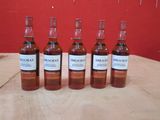 six bouteilles de whisky Macallan alignées sur une table