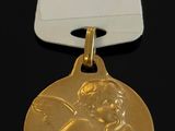 a close up of a gold medal with a tag on it