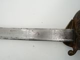 a close up of a knife on a white surface