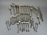 a lot of spoons and forks arranged together on a table