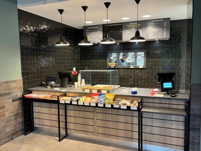 an image of a restaurant counter with a lot of food on it