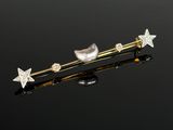 a close up of a pair of star and pearl hair pins
