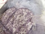 a purple and white dress sitting on top of a table
