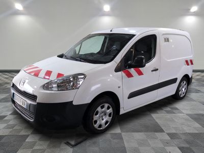 the white van is parked on a checkered floor in the garage
