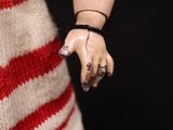 a doll that is wearing a sweater and holding a knife