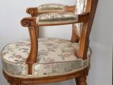 a wooden chair with a floral upholstered seat
