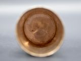 a close up view of a brown cup on a table