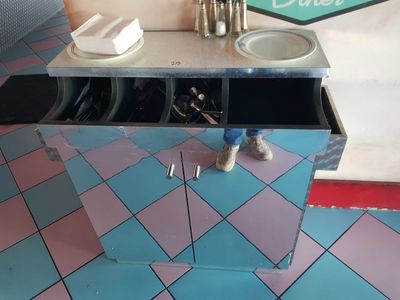 a person standing in front of a counter with plates on it