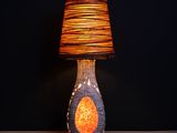 a lamp that is sitting on a table with a lamp on it